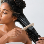 Woman caring for curly hair to reduce frizz in humid weather