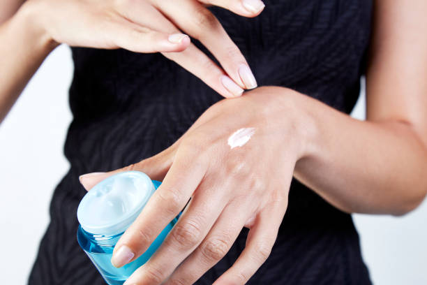 Woman applying face cream for cooler-weather skincare