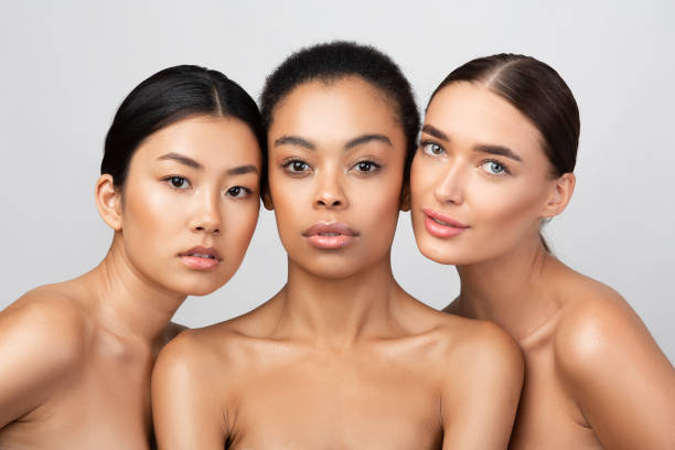 Three women posing together in a studio