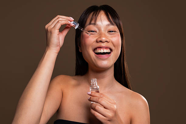 Woman applying facial serum with a dropper