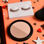 Fall makeup products with eyeshadow, false lashes and makeup brushes